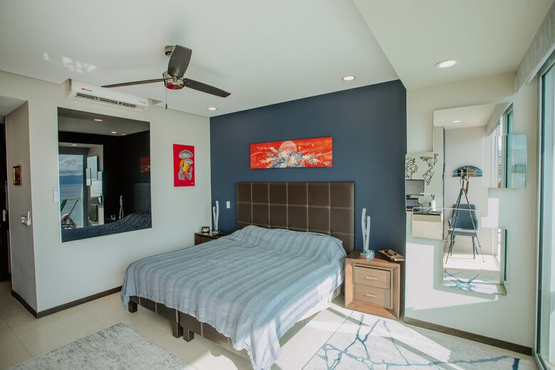 Spacious master with mirror brining ocean into the room