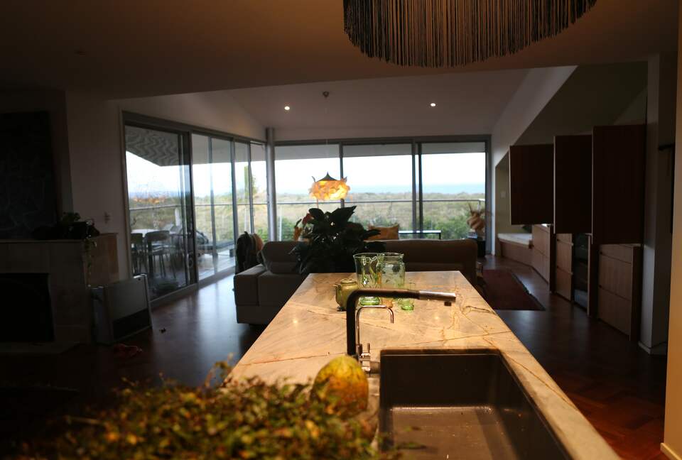open plan kitchen living and dining room with views to the ocean
