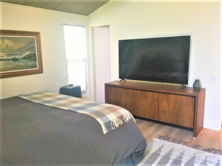 Primary bedroom 65 inch TV
