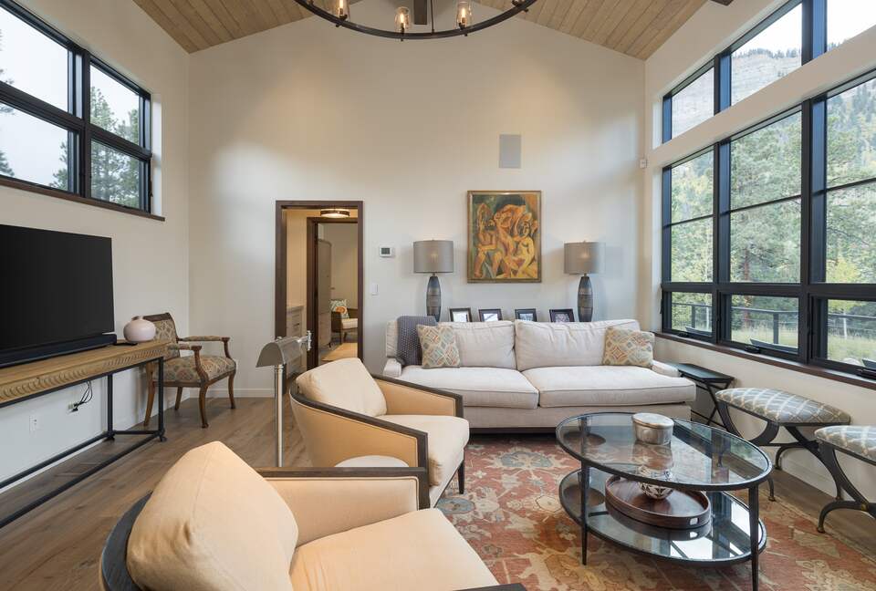 Living room with cliff views and large TV monitor.