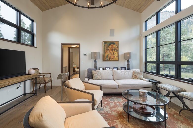 Living room with cliff views and large TV monitor.