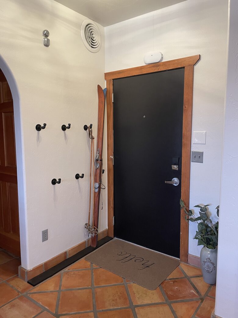 Hooks by front door to store coats, backpacks or skiis