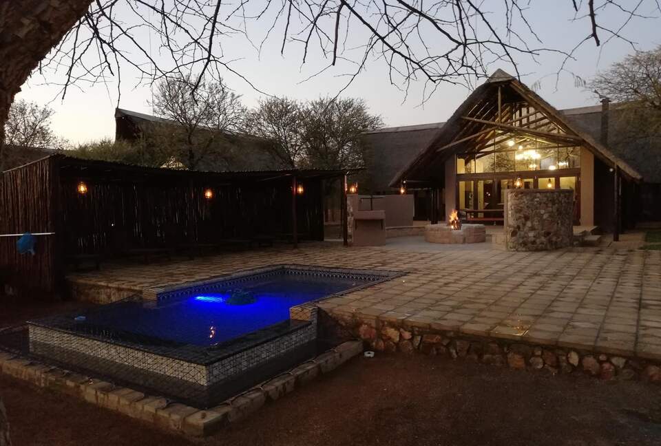 Pool, lapa and fire pit with the main lodge building