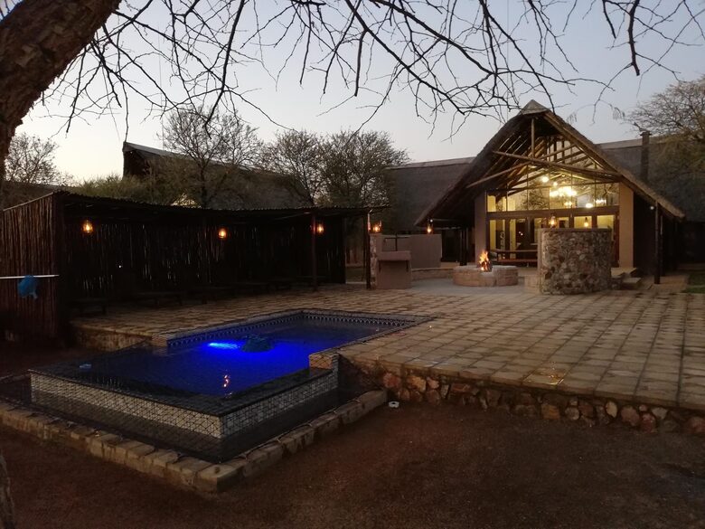 Pool, lapa and fire pit with the main lodge building