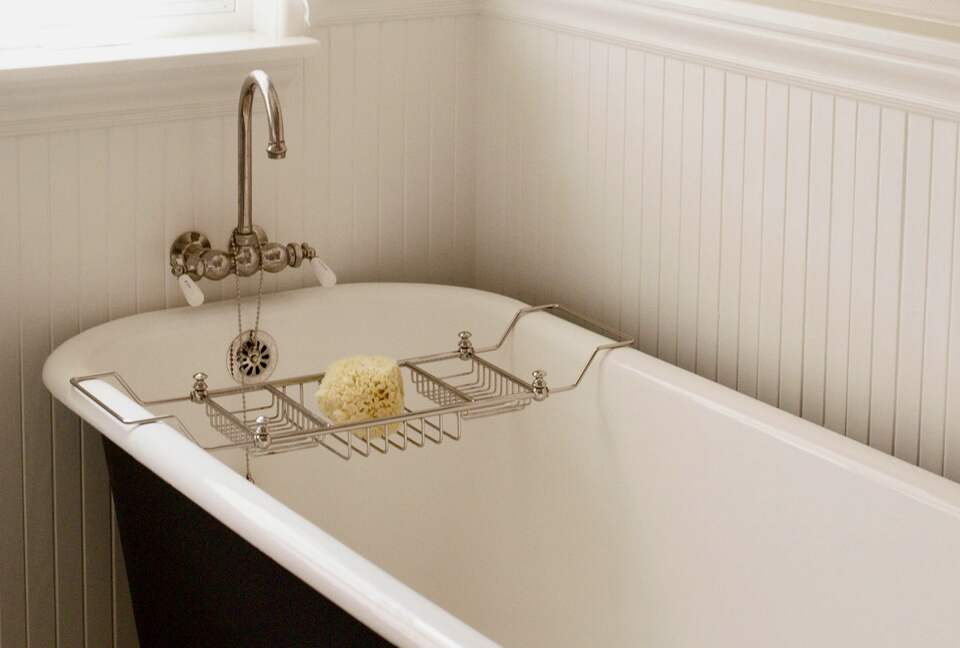 Hall bath with clawfoot tub and separate shower