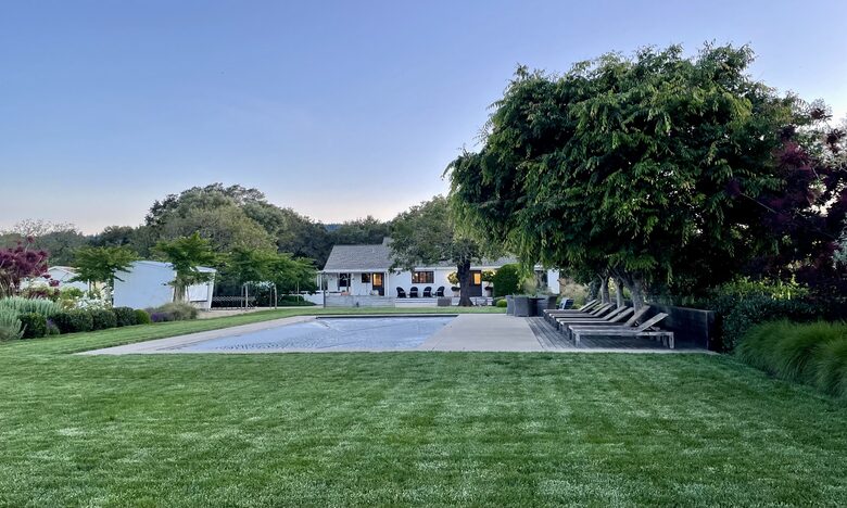 View of home from garden at dusk