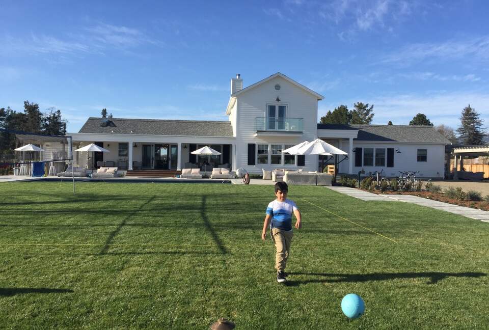Expansive lawn area between the bocce ball court and pool.
