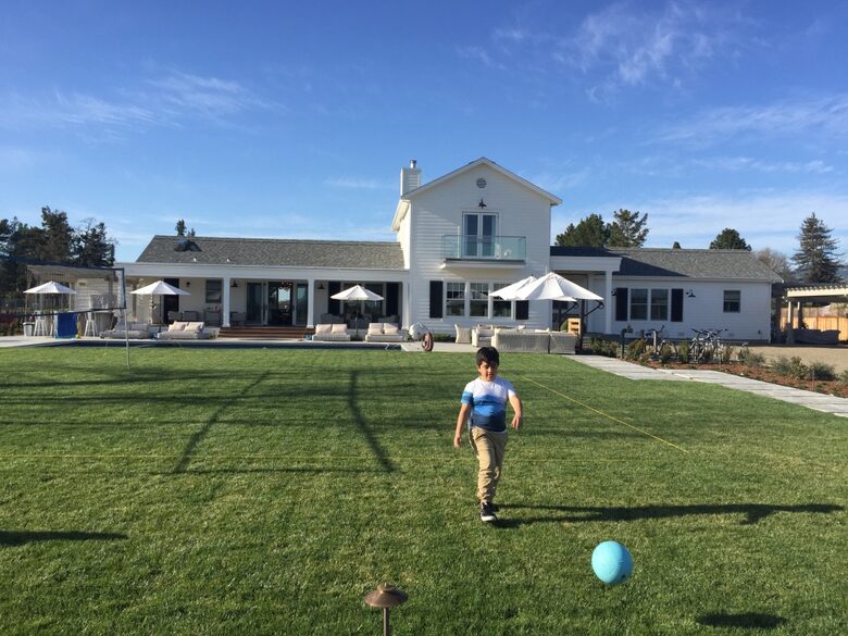 Expansive lawn area between the bocce ball court and pool.