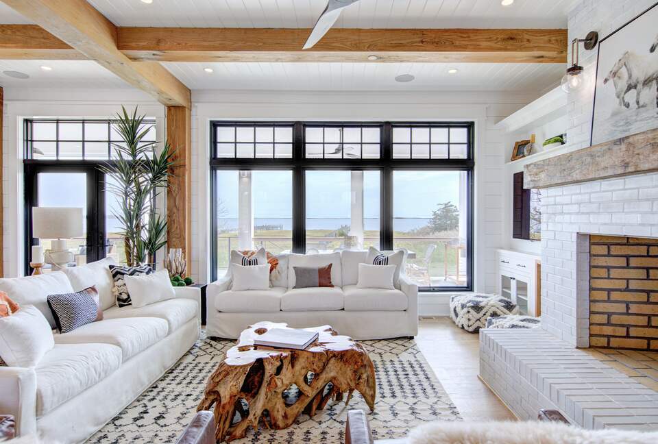 great room with windows out to porch, dock and bay