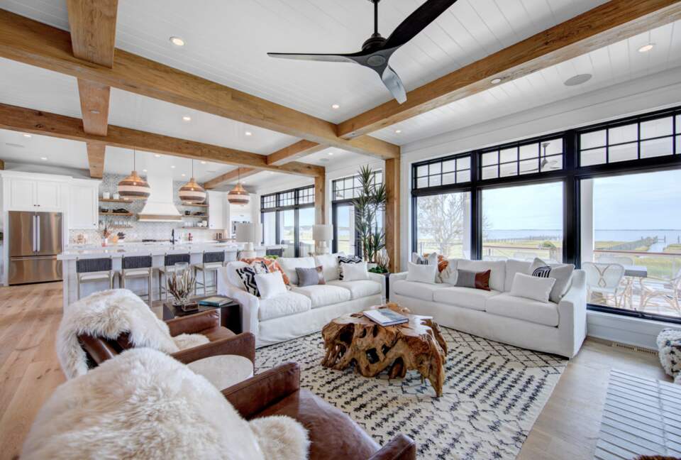 great room with windows out to porch, dock and bay