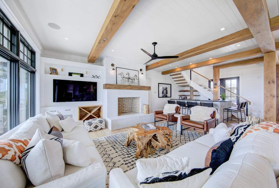 great room with tv and large masonry fireplace