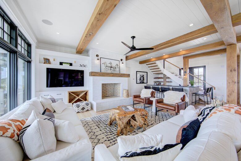 great room with tv and large masonry fireplace