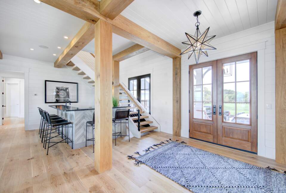 front door with bourbon bar and floating staircase