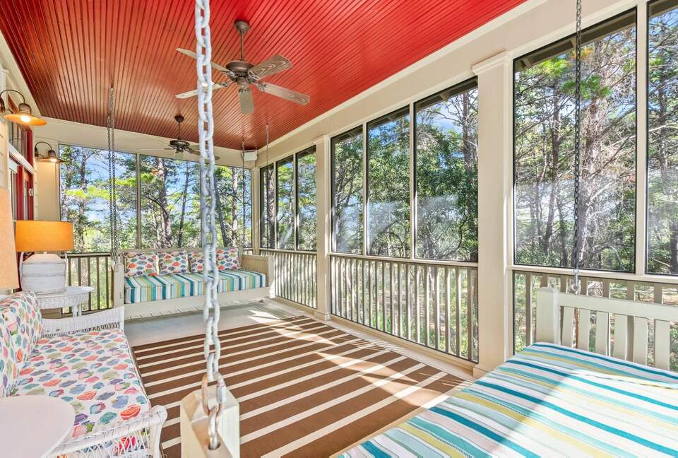 Screen back sleeping porch with 2 Q swing beds in tree tops.