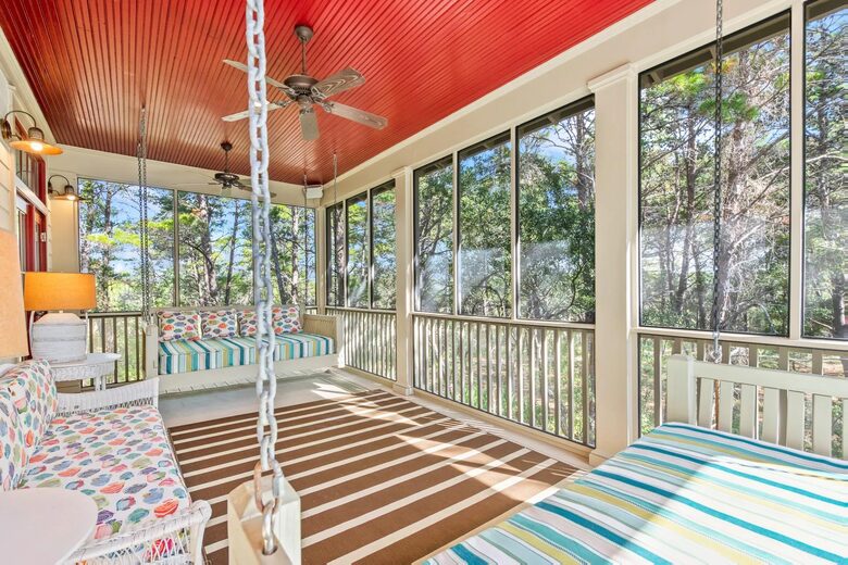 Screen back sleeping porch with 2 Q swing beds in tree tops.
