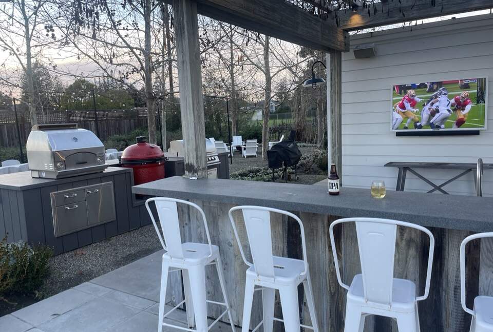 The first of 2 outdoor bars, with TV, fridge, and BBQ area.