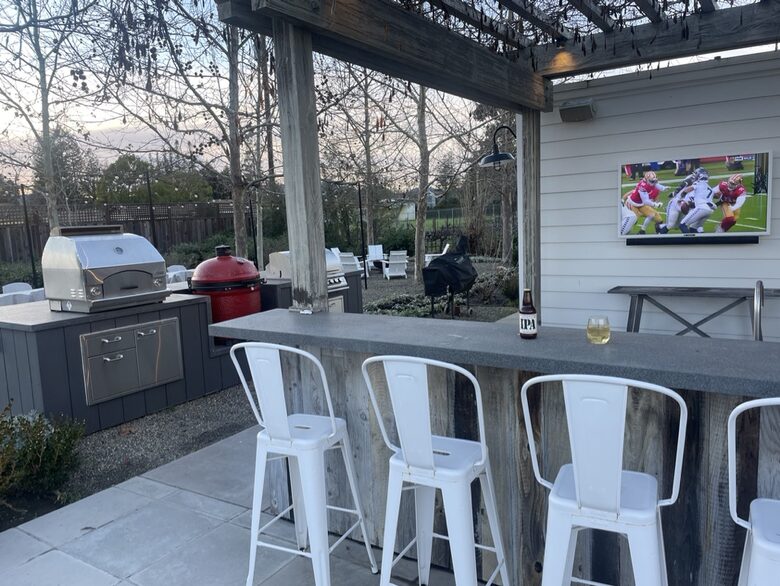 The first of 2 outdoor bars, with TV, fridge, and BBQ area.