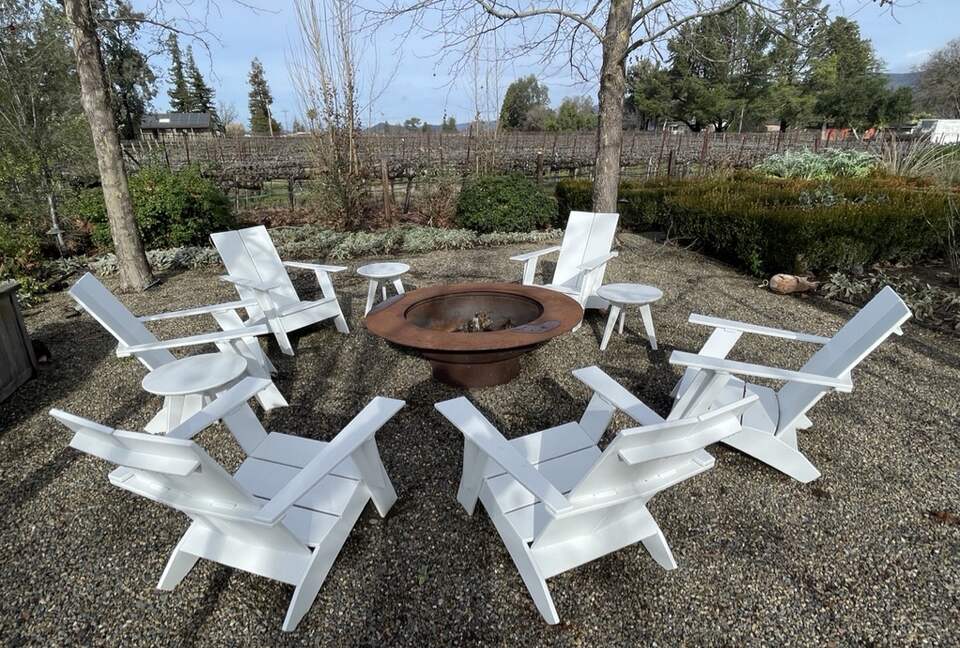 The first of 2 fire-pits, adjacent to outdoor dining table.