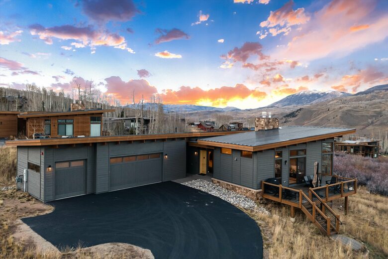 Front of home and 3 car heated garage with Tesla charger.