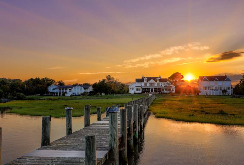 view of home at dusk from halfway down dock