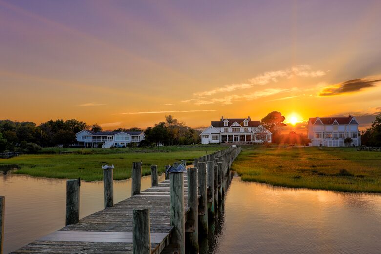 view of home at dusk from halfway down dock