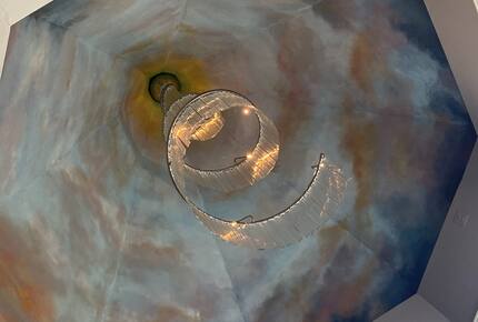 ceiling in primary bedroom featuring an original Vavini chandelier