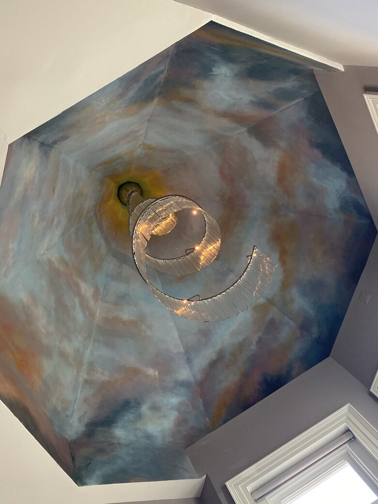 ceiling in primary bedroom featuring an original Vavini chandelier