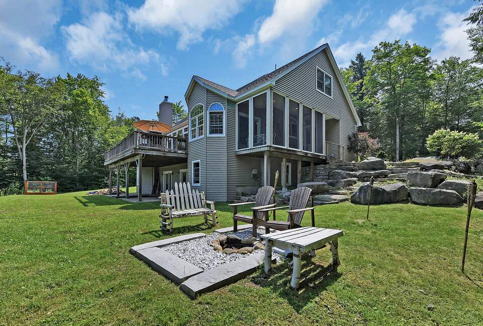 FIRE PIT AND VIEW OF BACK OF THE HOUSE