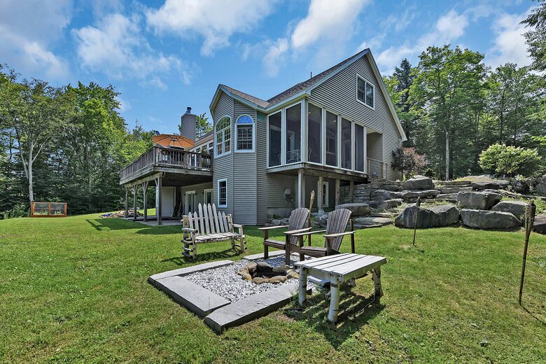 FIRE PIT AND VIEW OF BACK OF THE HOUSE