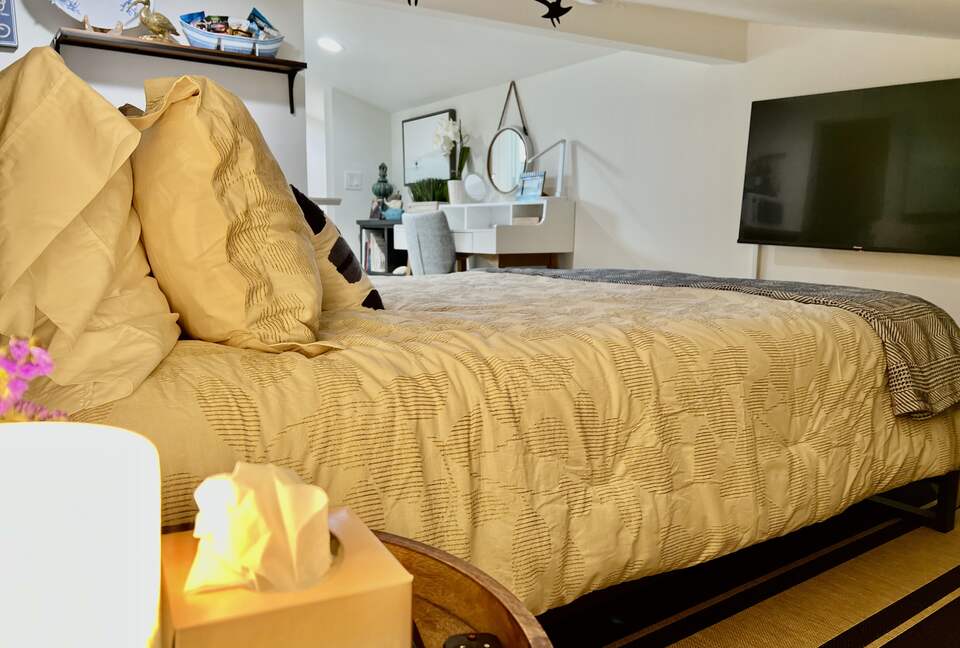 Detached bedroom above garage with workspace.