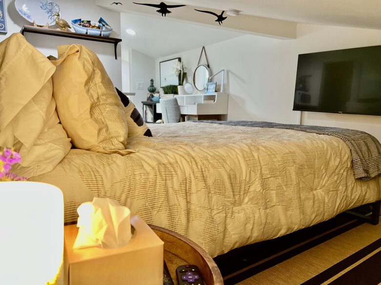 Detached bedroom above garage with workspace.