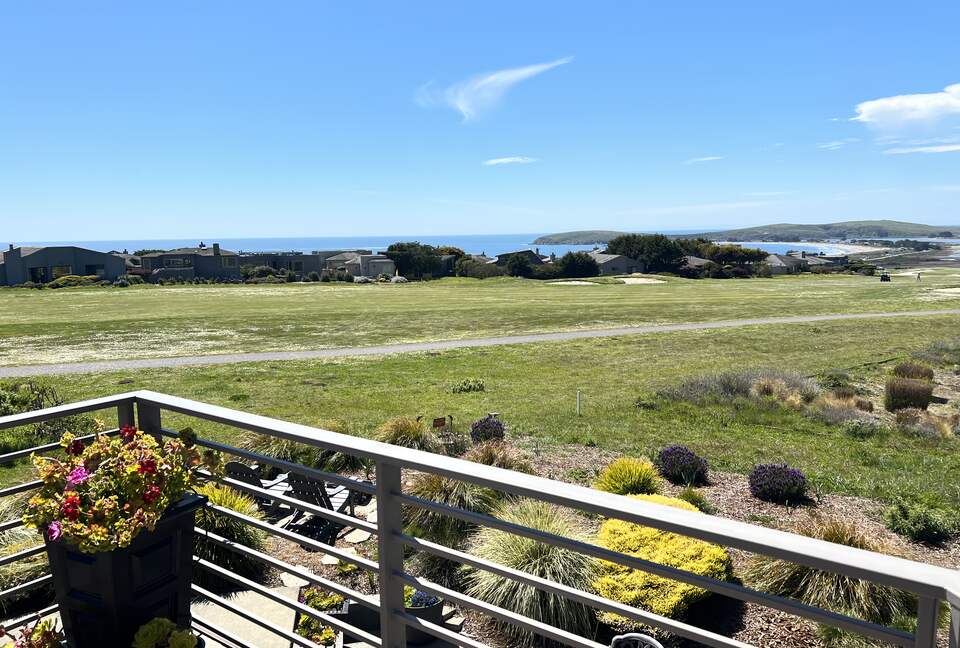 Looking down from primary bedroom balcony down onto patio.