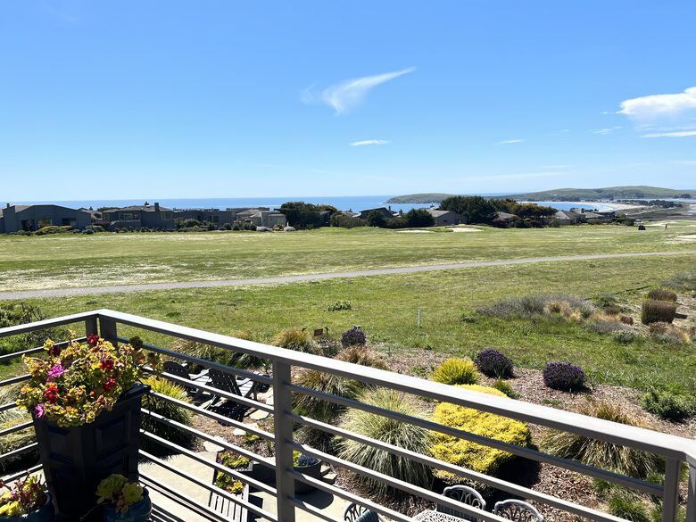 Looking down from primary bedroom balcony down onto patio.