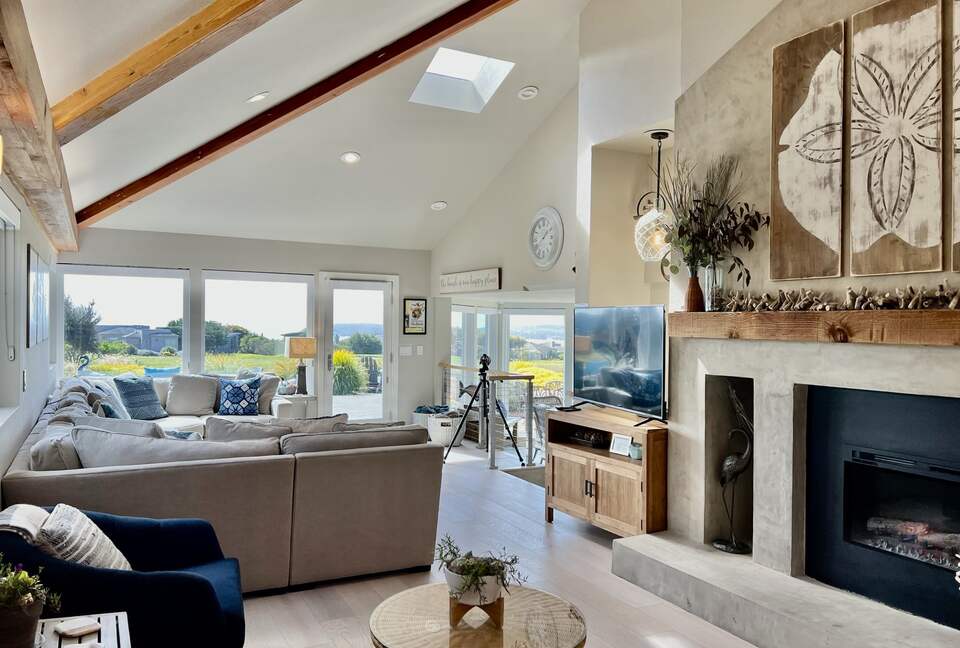 Large sofa, telescope, smart TV and electric fireplace.