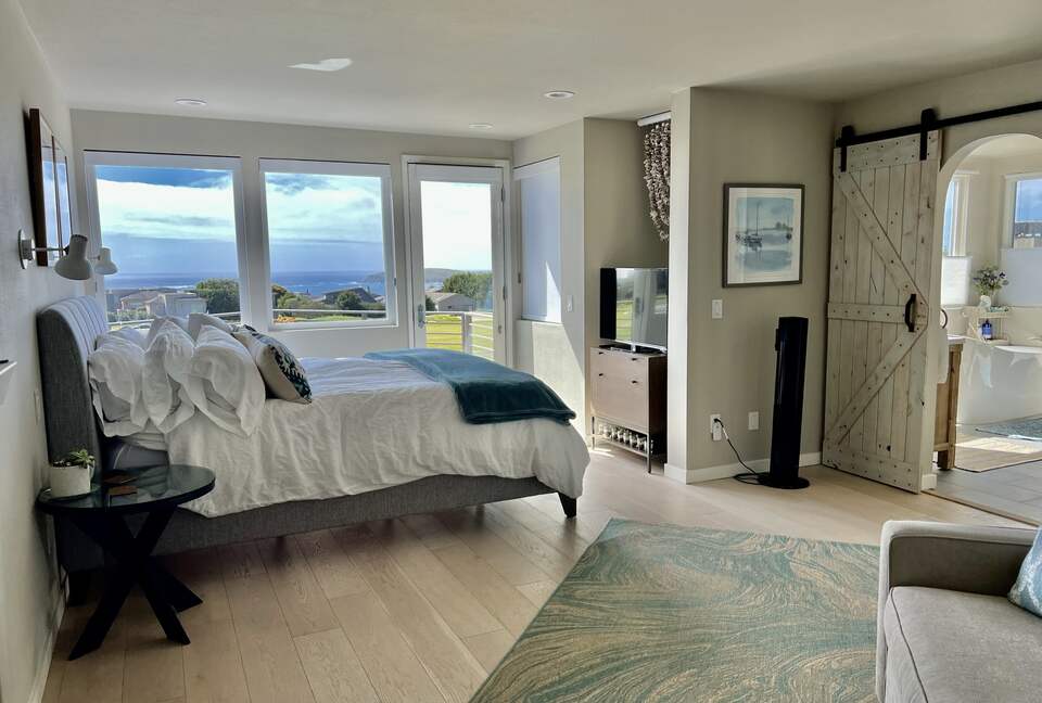 Primary bedroom with CA king bed views of fairway & ocean.