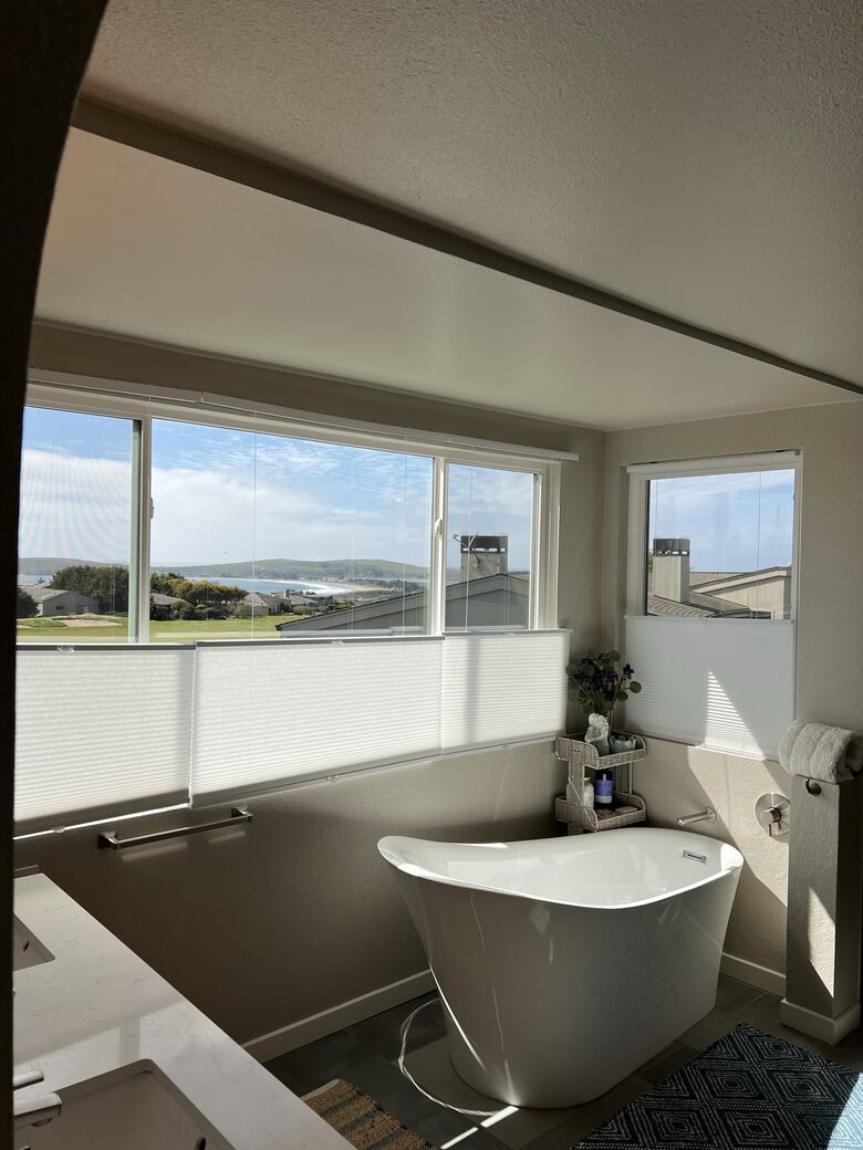 Panoramic water views with tub and walk in shower.