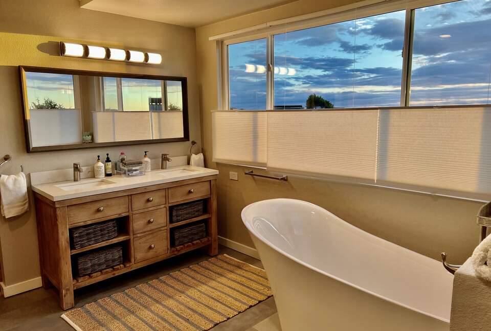 Upstairs primary en suite bathroom with dual vanity.