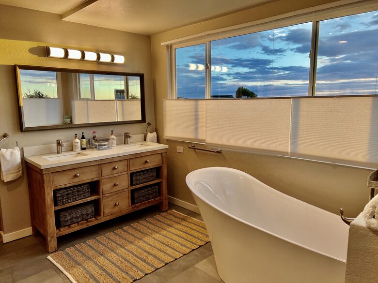 Upstairs primary en suite bathroom with dual vanity.