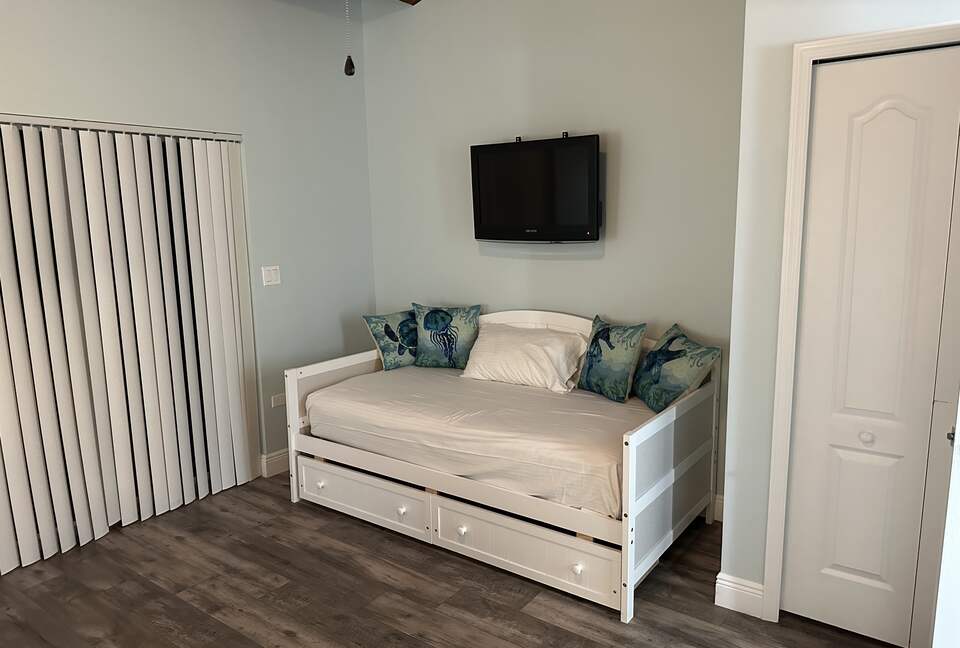Second bed in guest bedroom with storage
