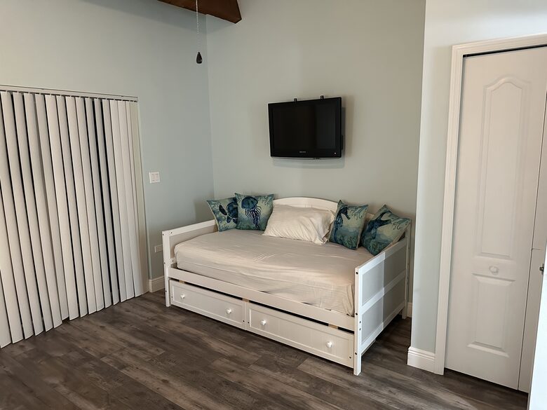 Second bed in guest bedroom with storage