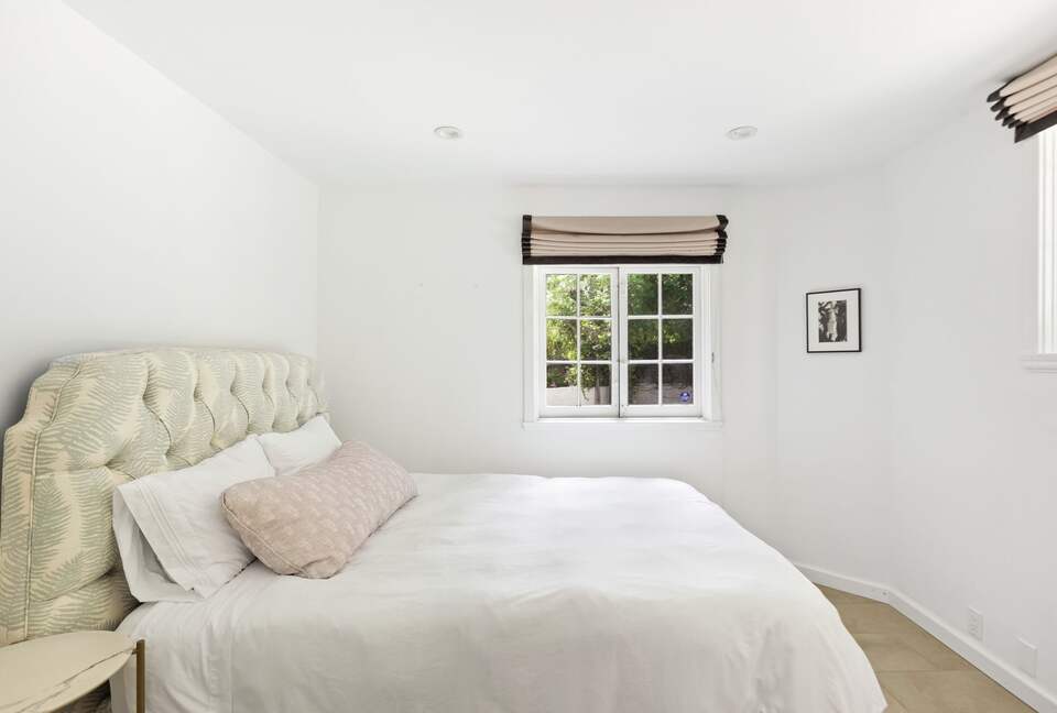 Lower level guest room with queen bed and private bath