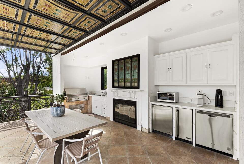 Second floor patio with grill, dining table and sitting area