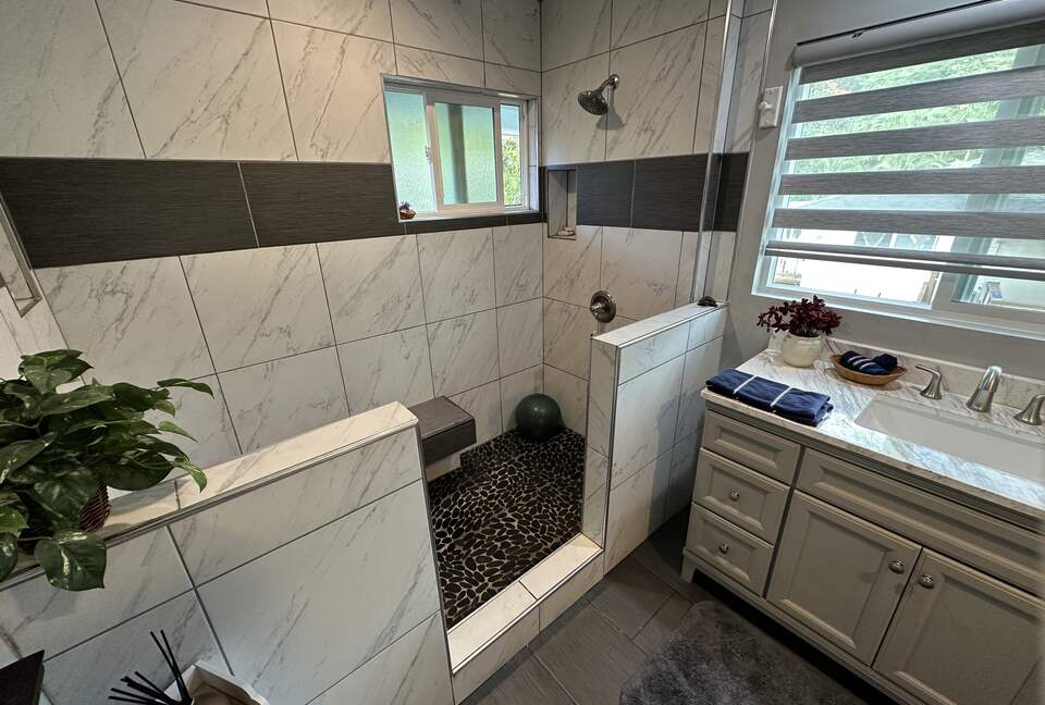 Smooth river rock shower with double head shower