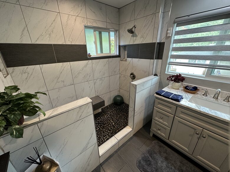 Smooth river rock shower with double head shower