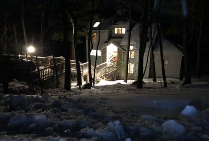 A winter view from the road looking down at the home.