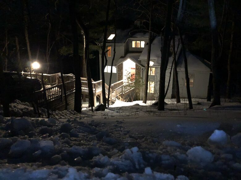 A winter view from the road looking down at the home.