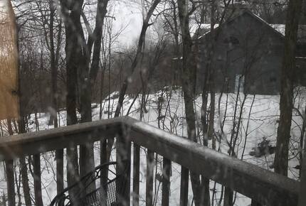 Winter photo showing the deck and nearest neighbor's home.