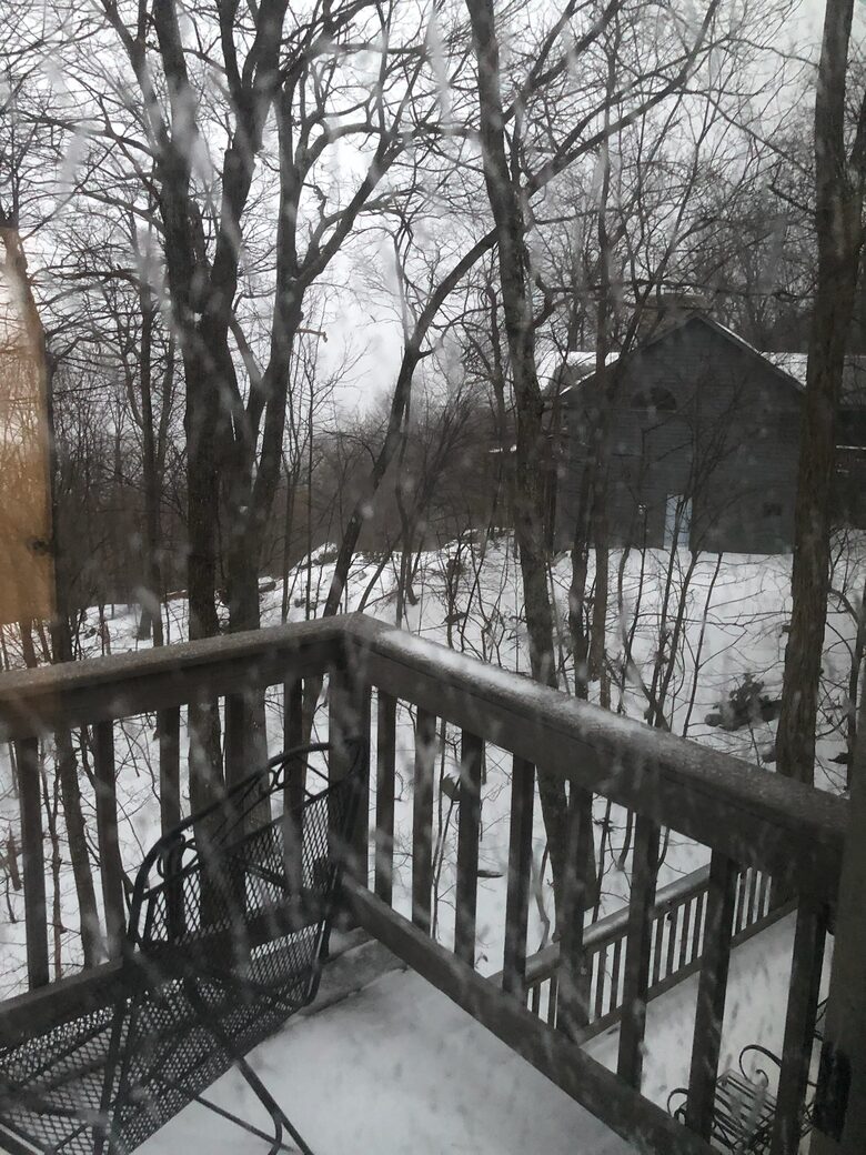 Winter photo showing the deck and nearest neighbor's home.
