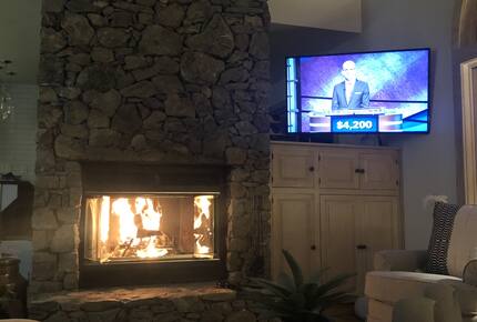 Family room with wood-burning fireplace and streaming TV.