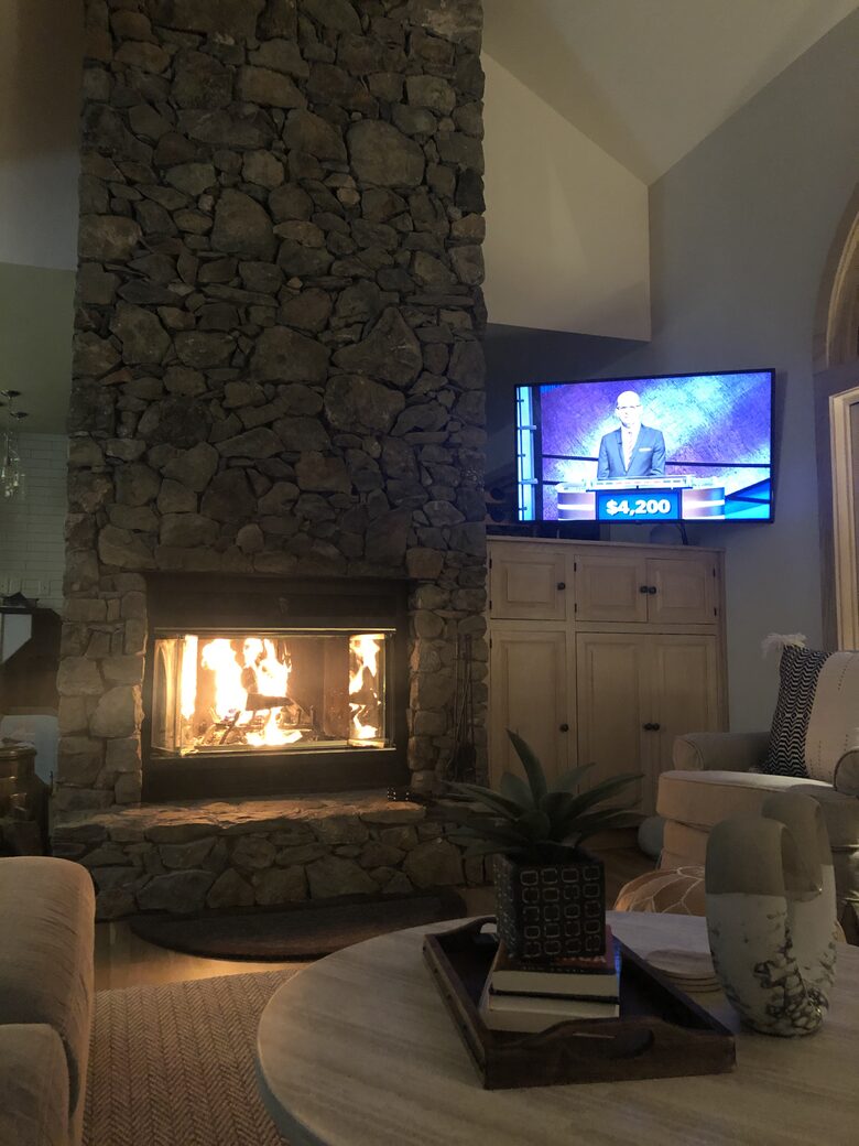 Family room with wood-burning fireplace and streaming TV.